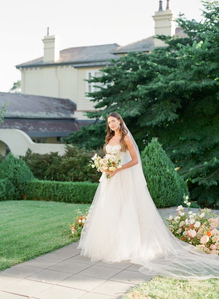 bride with bouquet and ground arbour